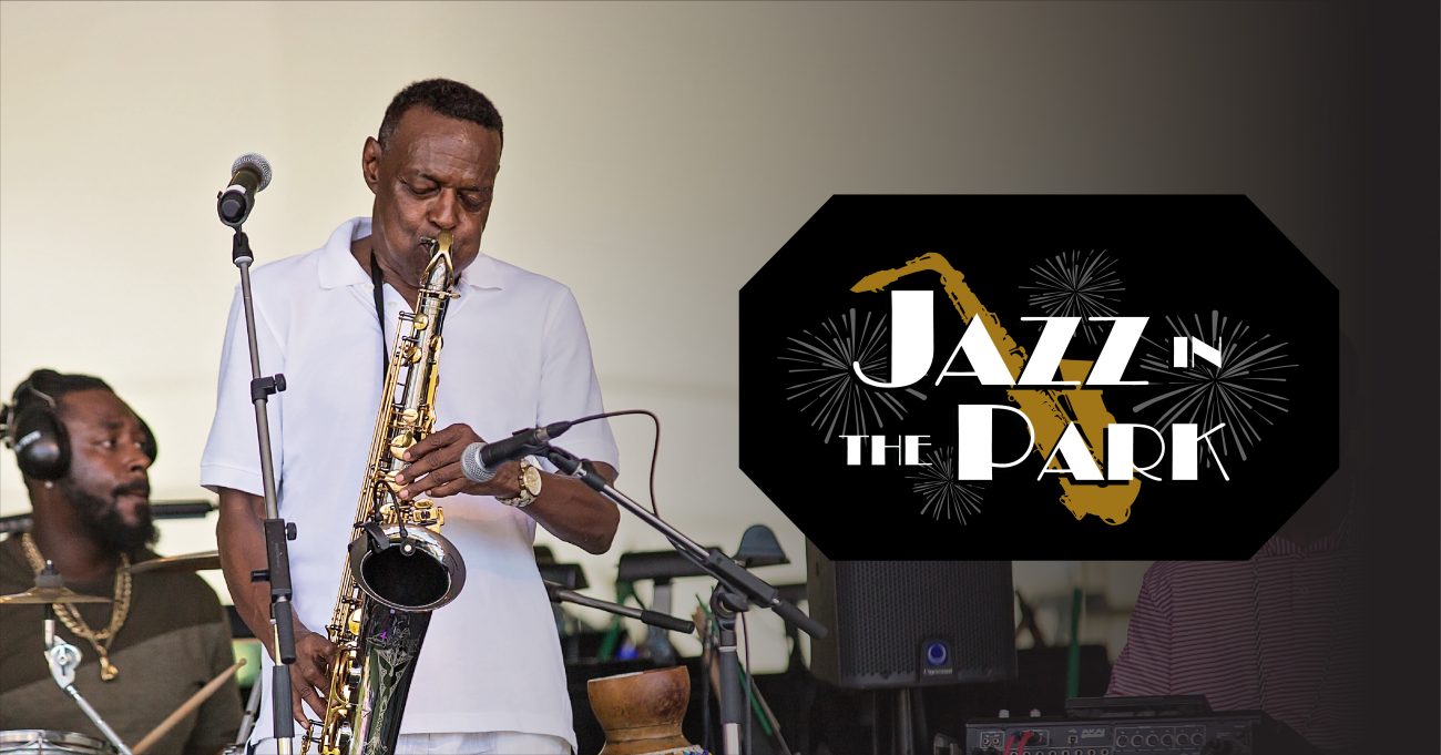 J Plunky Branch is playing the saxophone on stage. On the left, a logo for Jazz in the Park featuring a sax and fireworks.