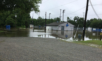 Flooded area over road with building in water.
